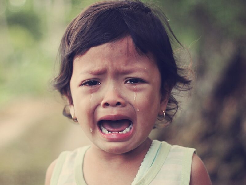 selective focus photography of girl crying