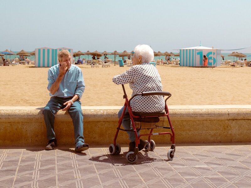 a man sitting on a bench next to a woman