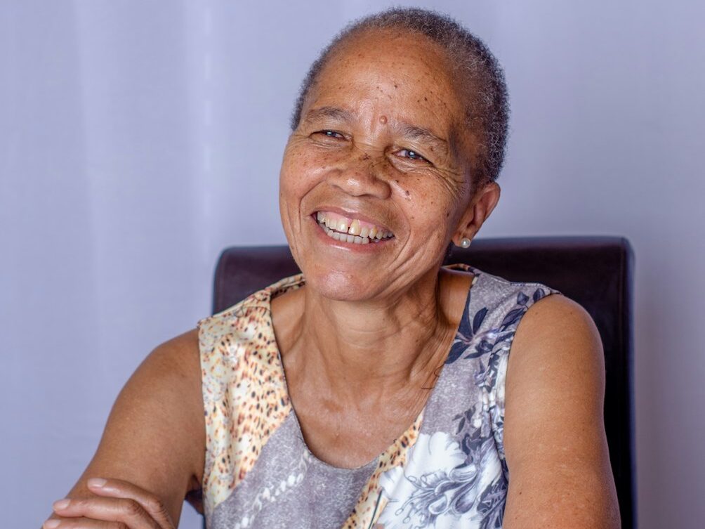 woman in white and gray tank top sitting on black chair