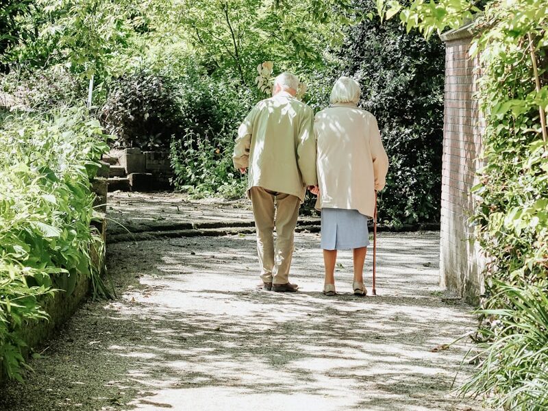 man and woman walking on road during daytime