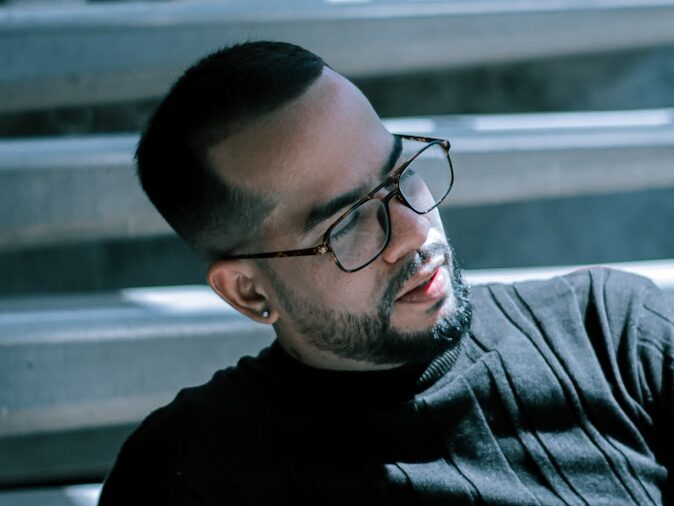 man in black crew neck shirt wearing black framed eyeglasses
