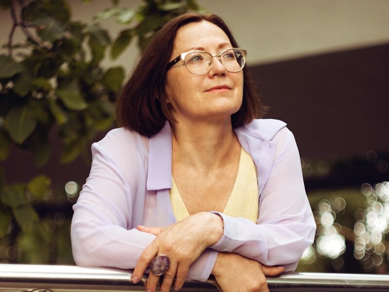 woman in white blazer and yellow dress shirt