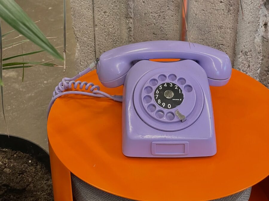 a purple phone sitting on top of an orange table
