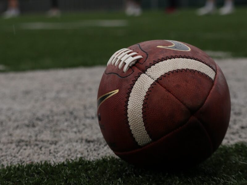 a football sitting on top of a lush green field