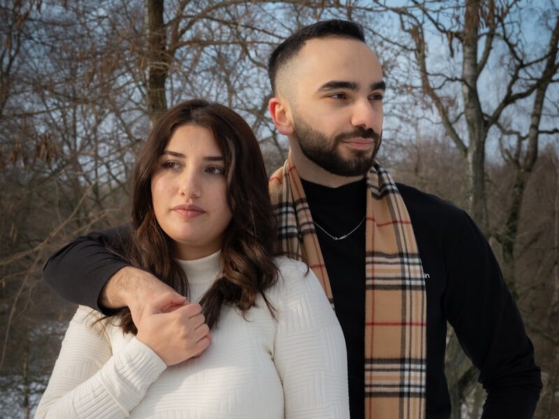 a man and a woman standing in the snow