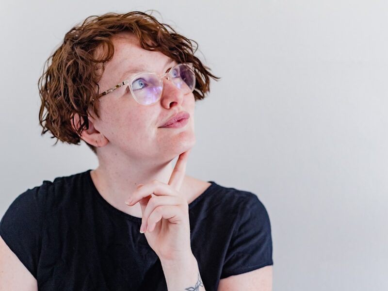 a woman wearing glasses and a black shirt