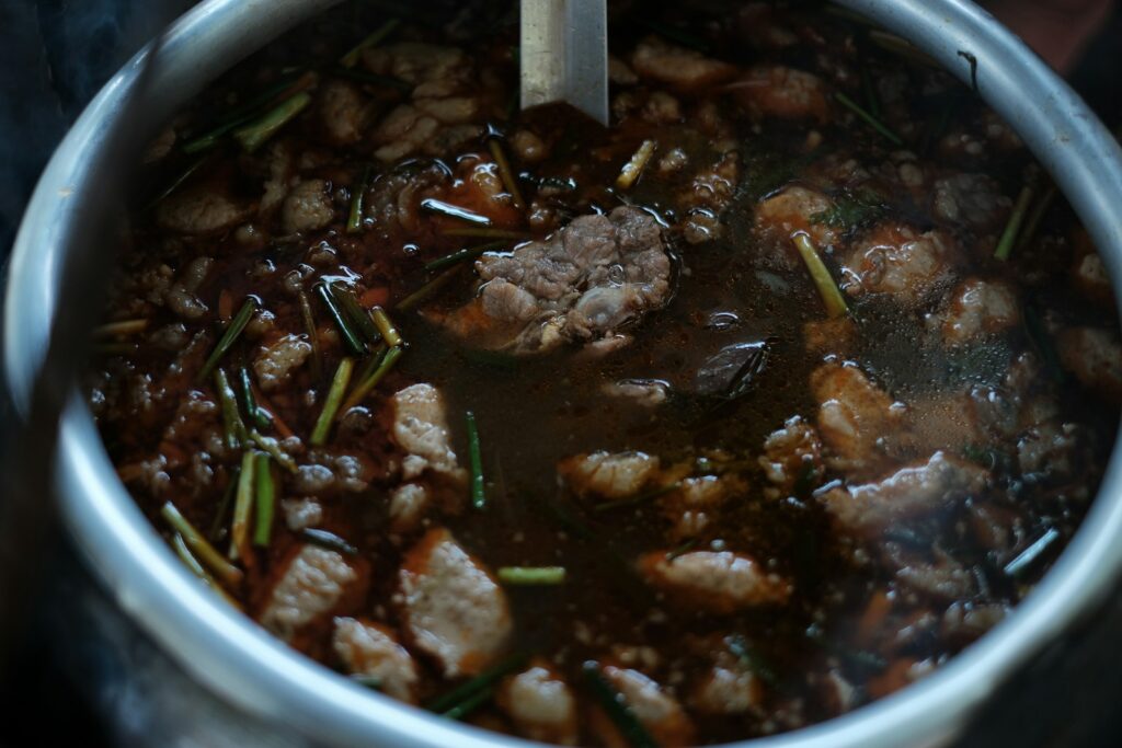 a pot filled with meat and vegetables on top of a stove