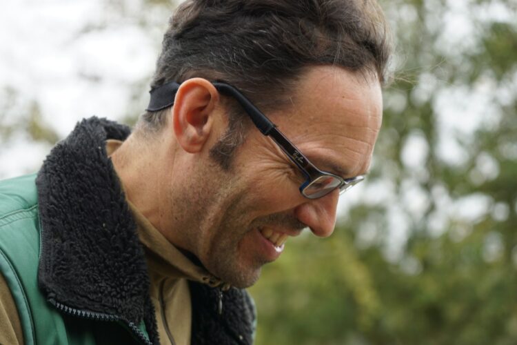 man in black framed eyeglasses and black and white scarf