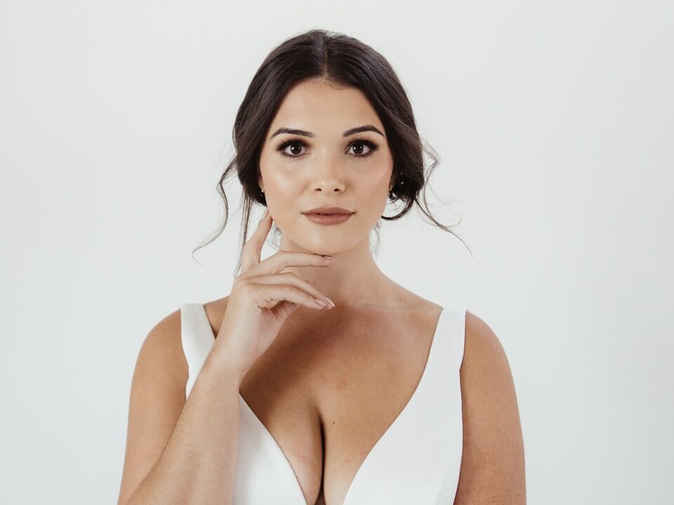a woman in a white dress posing for a picture