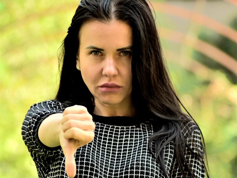 A woman pointing a gun at the camera
