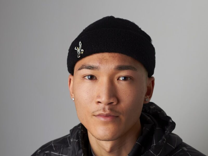 man wearing Lacoste zip-up hooded top