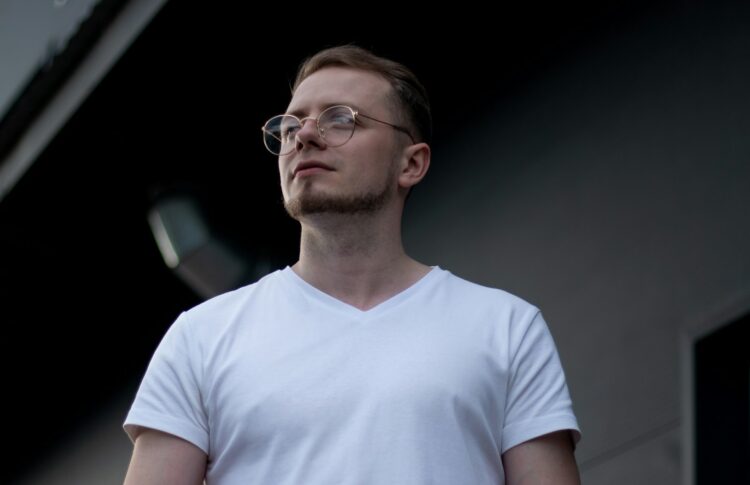 a man wearing glasses and a white shirt