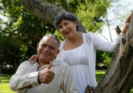 Happy senior couple poses for a photo outdoors.