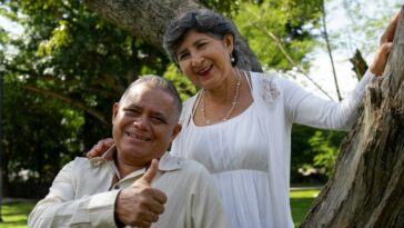 Happy senior couple poses for a photo outdoors.