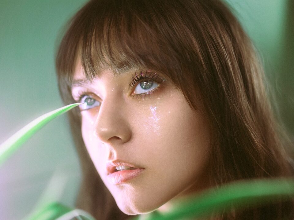 a close up of a person near a plant