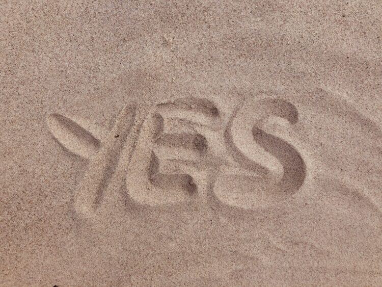 yes text on brown sand