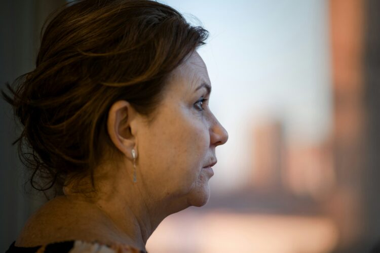 a close up of a person with a city in the background