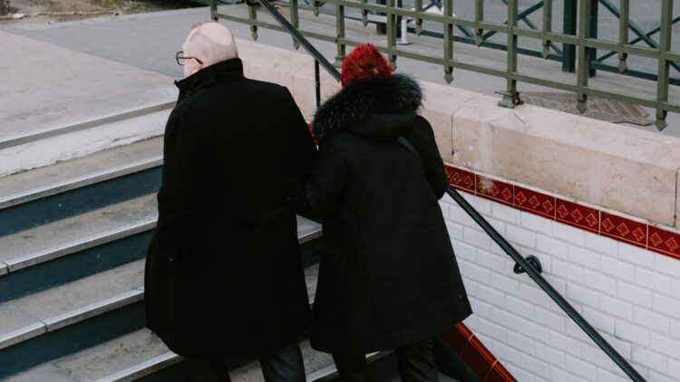 a couple of people that are standing on some stairs