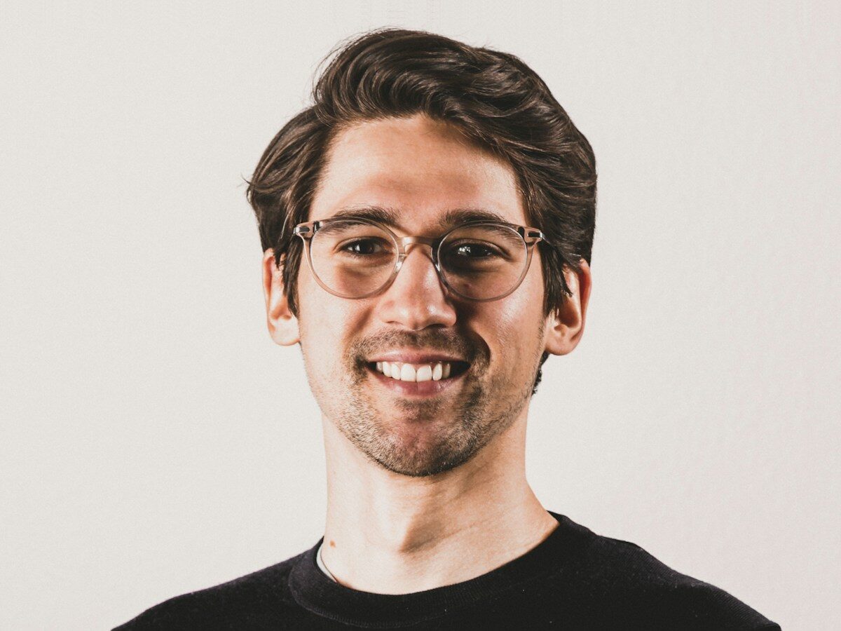 a man wearing glasses and a black shirt