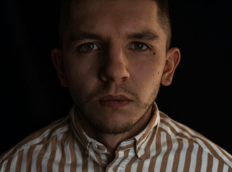 man in white and black striped collared shirt