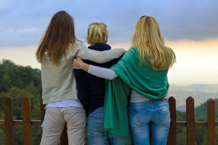 a group of three women standing next to each other