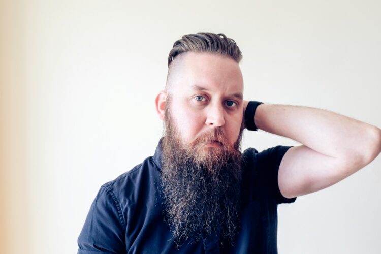 a man with a long beard and a black shirt