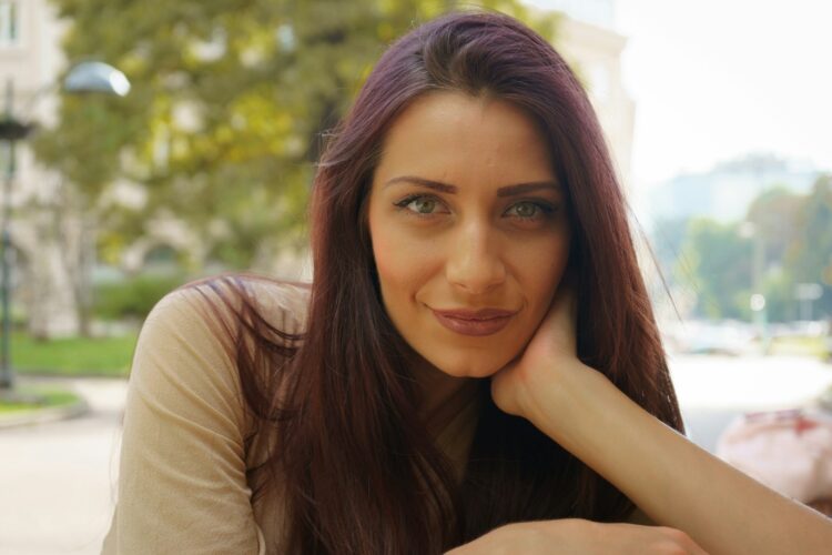 a woman with her hand on her chin