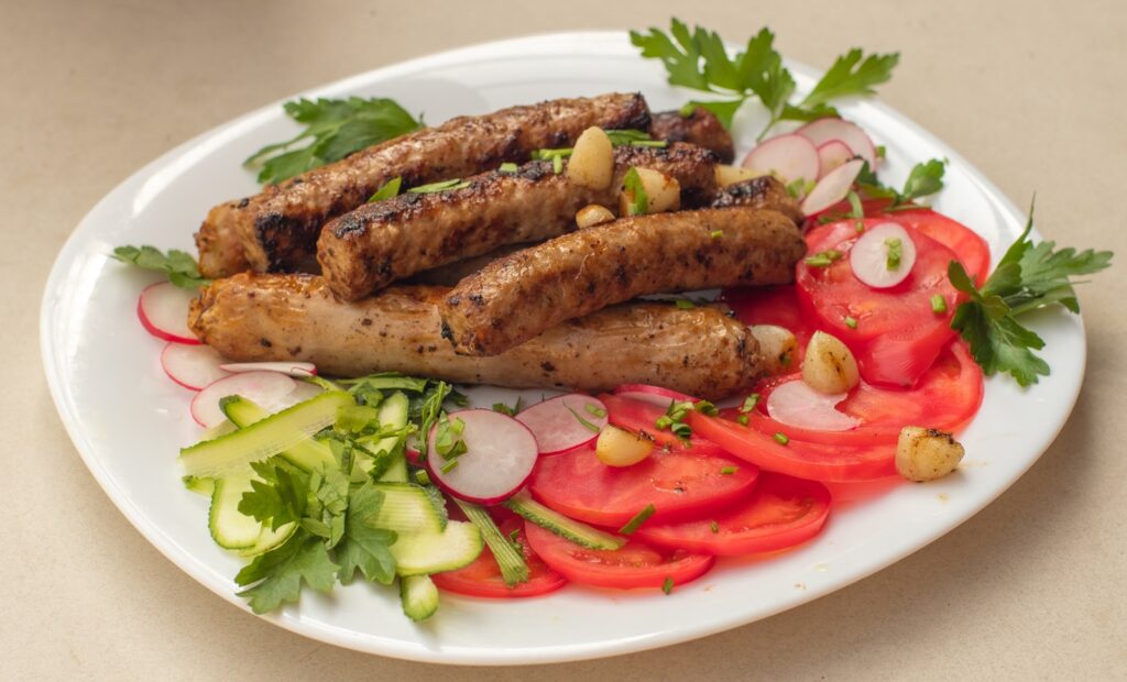 a white plate topped with meat and veggies