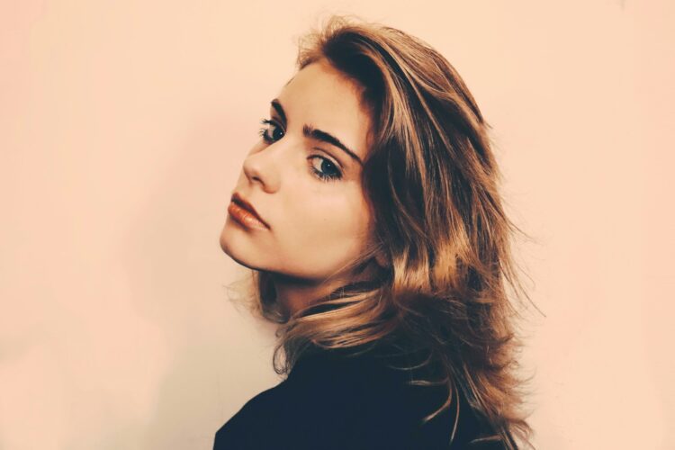 a woman with long hair and a black shirt