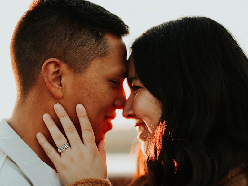 a man and a woman standing close to each other