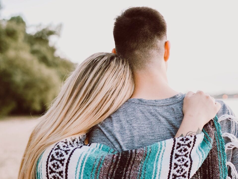 woman's hand on man's shoulder