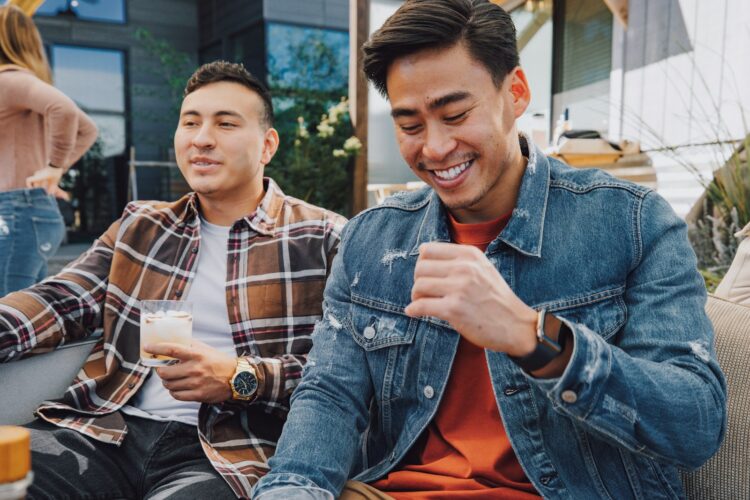 a couple of men sitting next to each other