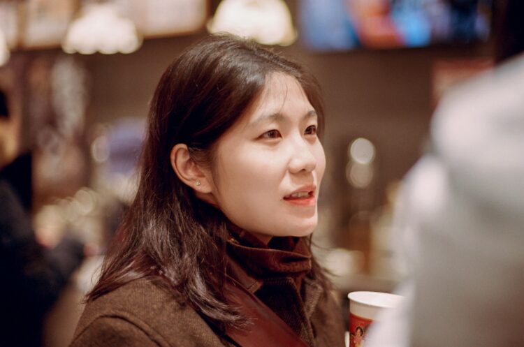 A woman holding a cup of coffee in her hand