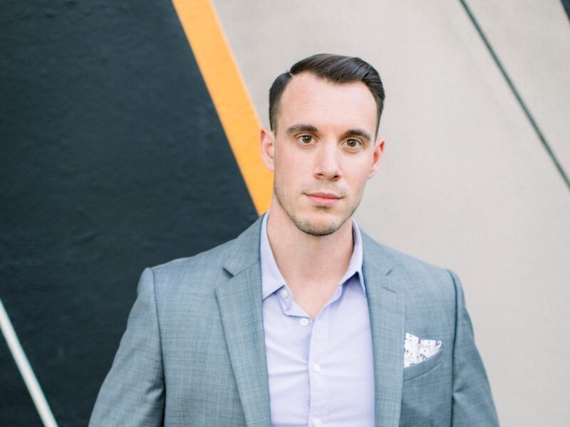 man in gray suit jacket standing