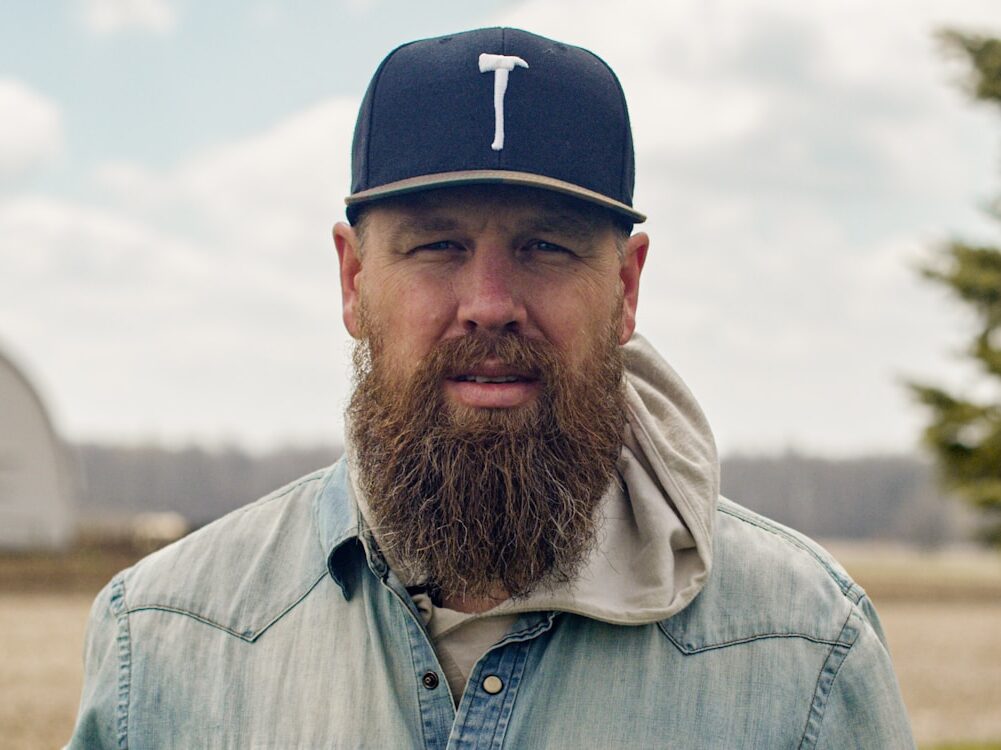 a man with a long beard wearing a hat
