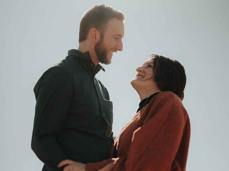 a man and a woman standing close to each other