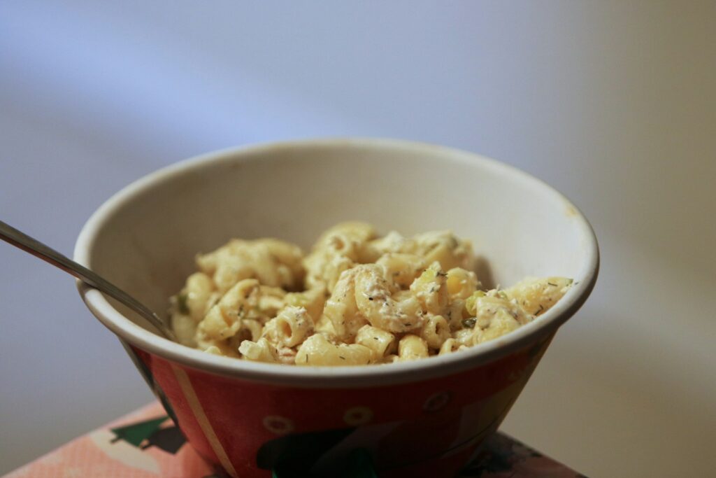 a bowl of macaroni and cheese with a spoon in it