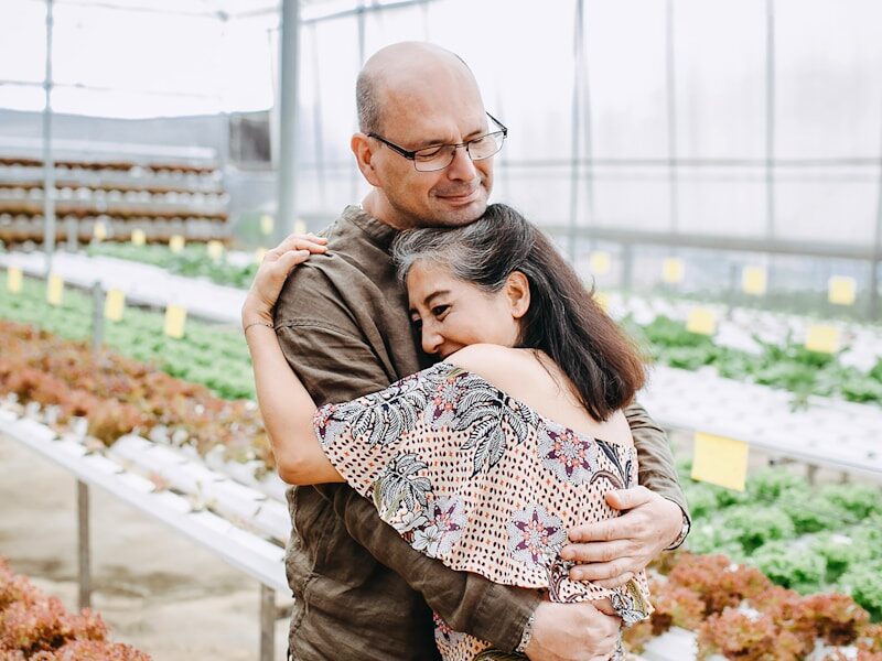 man hugging woman inside garden house