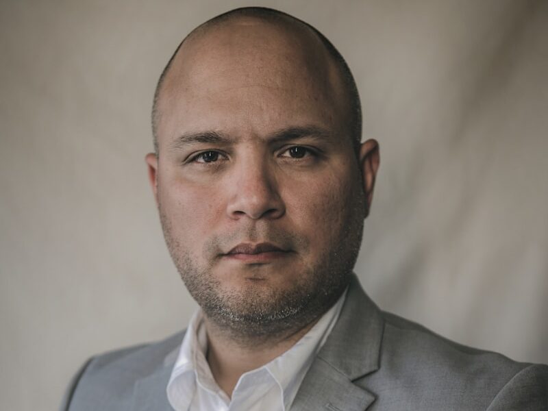 a man in a gray suit and white shirt