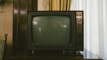turned-off gray CRT TV on table