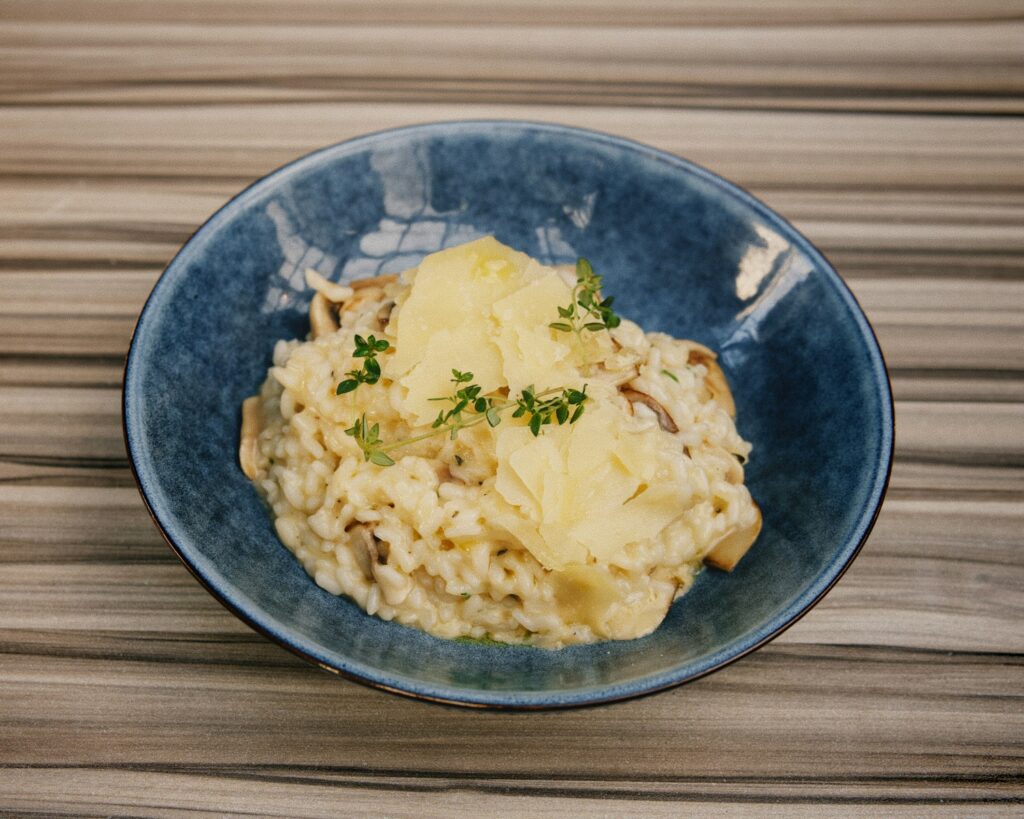 A blue bowl filled with food on top of a wooden table