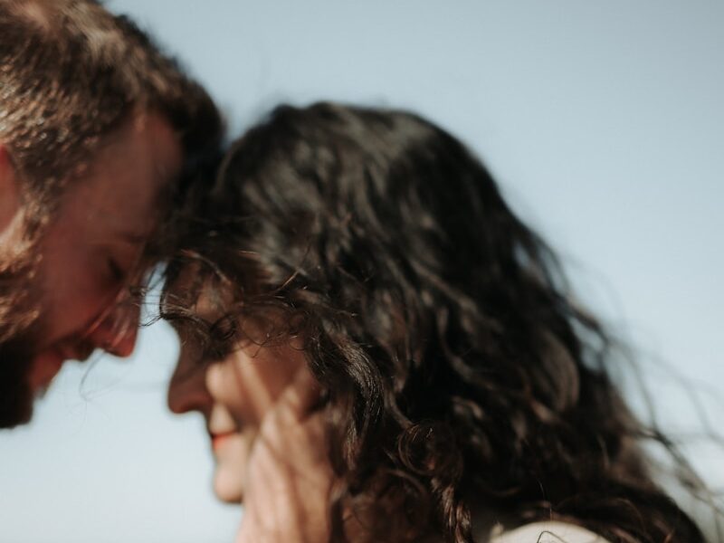 a man and a woman standing close to each other
