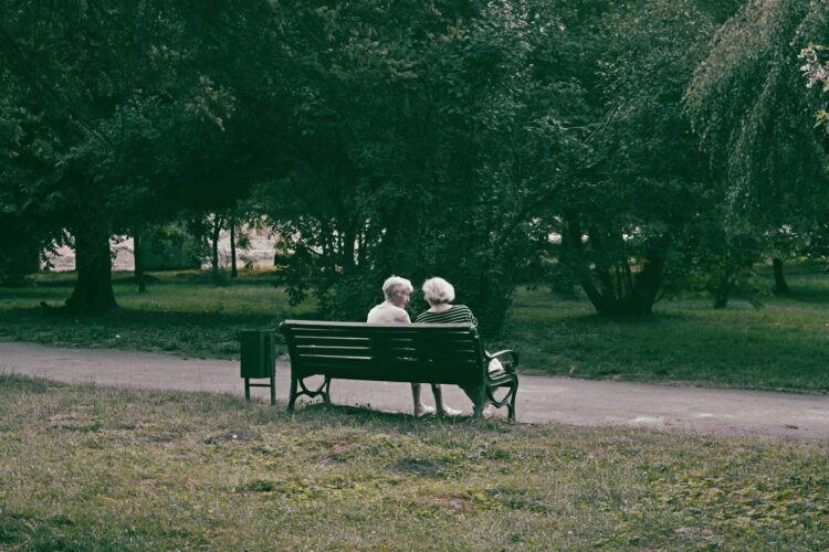 an elderly couple sitting on a bench