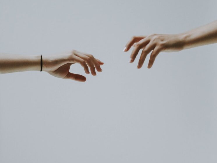 two hands about to hold wallpaper