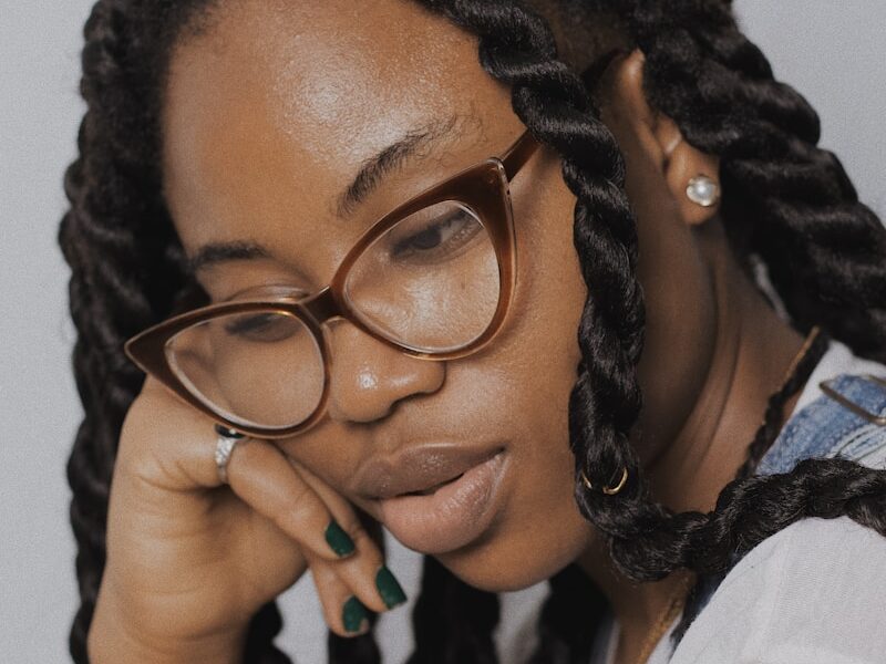 woman in white shirt wearing black framed eyeglasses