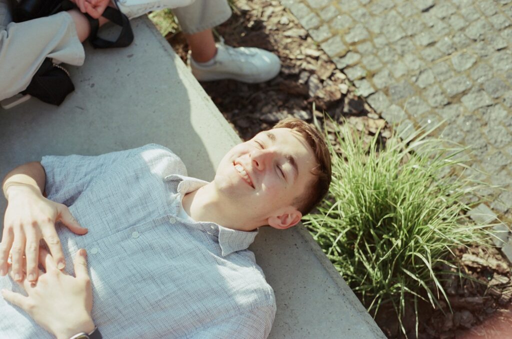 A man laying on the ground next to a woman