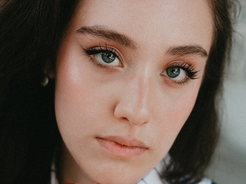 Close-up portrait of a young woman with striking eyes and elegant expression. Perfect for lifestyle and fashion themes.