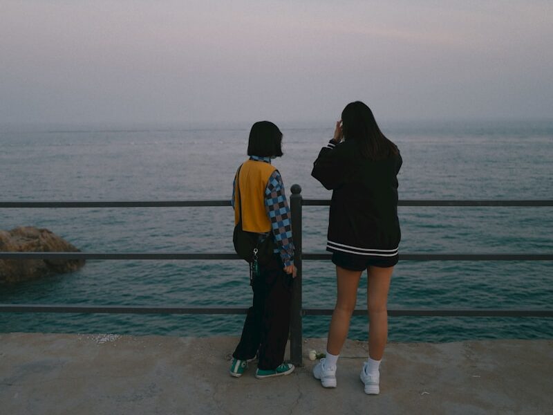 couple standing on beach during daytime