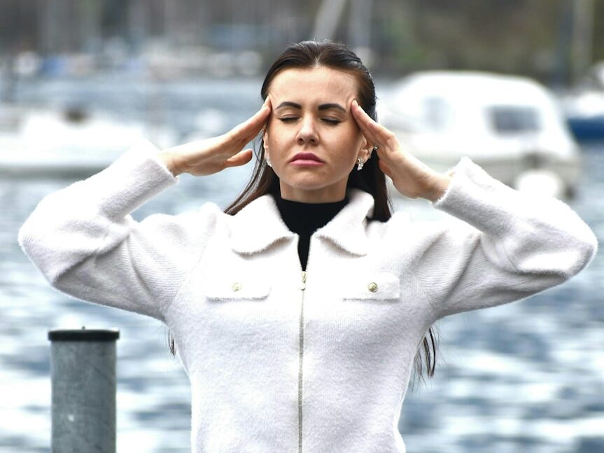A woman in a white jacket and black skirt
