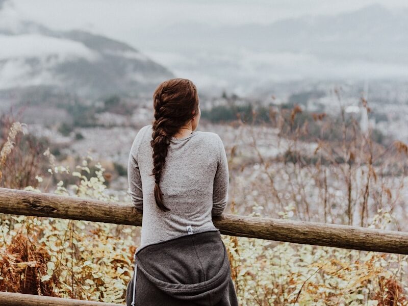 standing woman in grey long-sleeved shirt